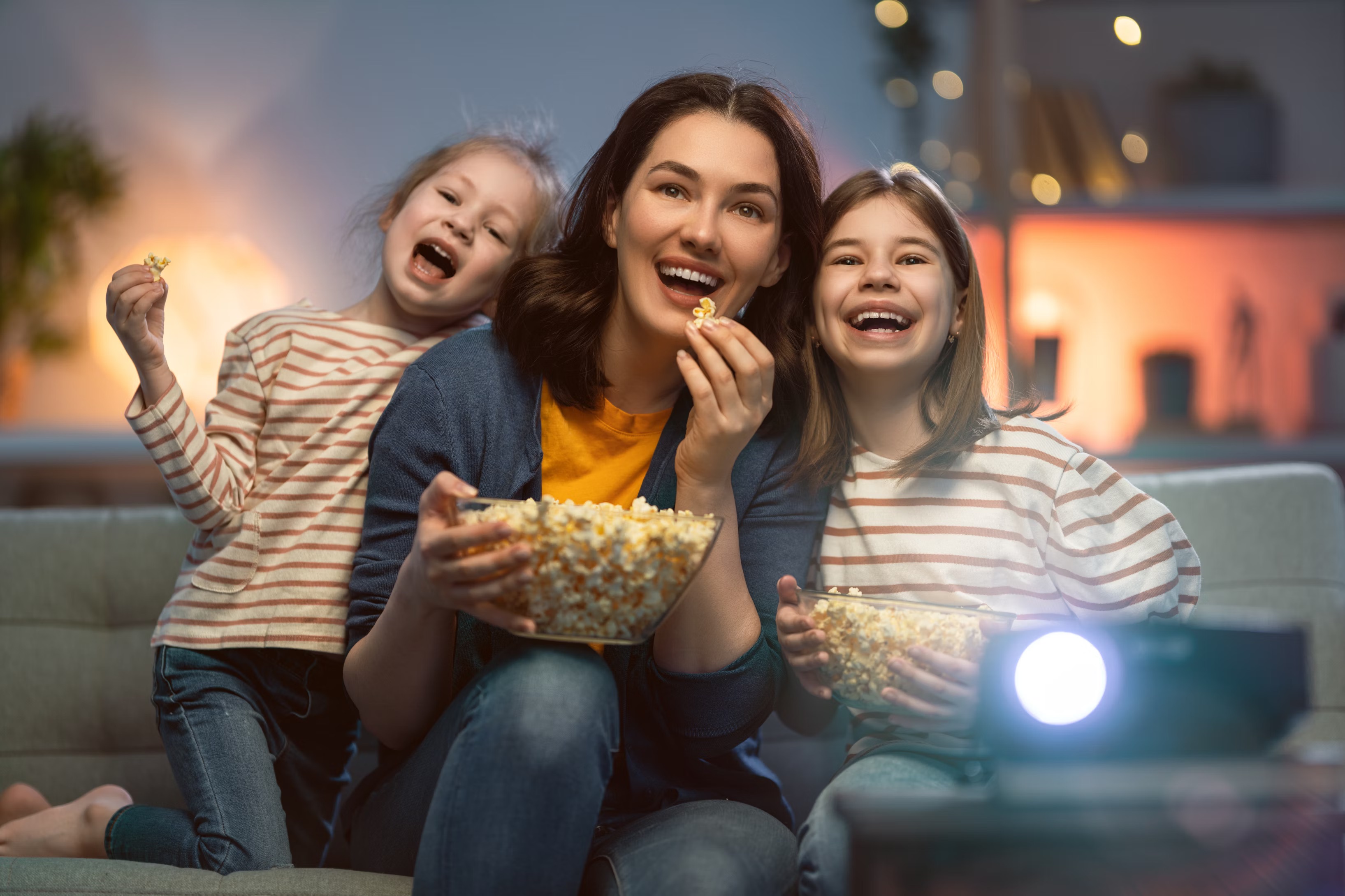 Family enjoying movie night together on the couch